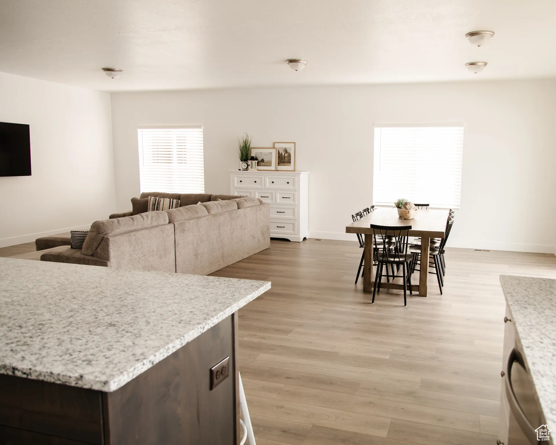 Living area with light wood-style flooring and baseboards