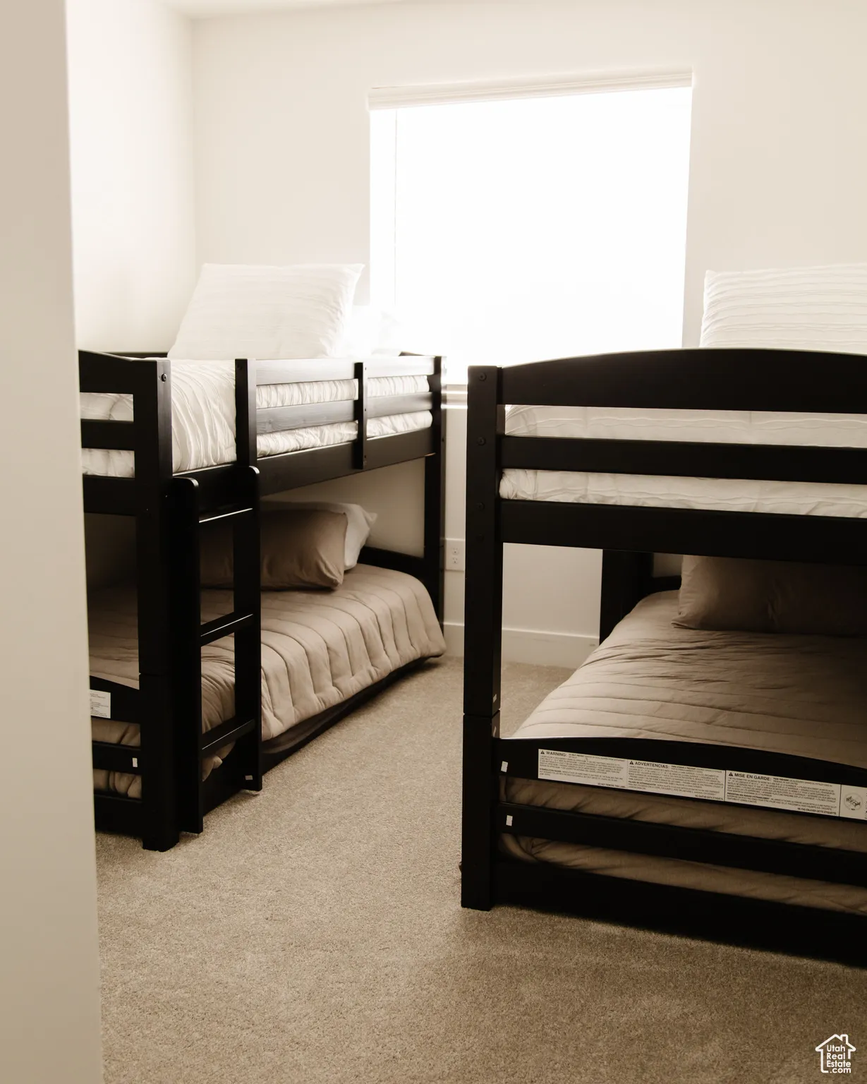 Bedroom featuring light colored carpet