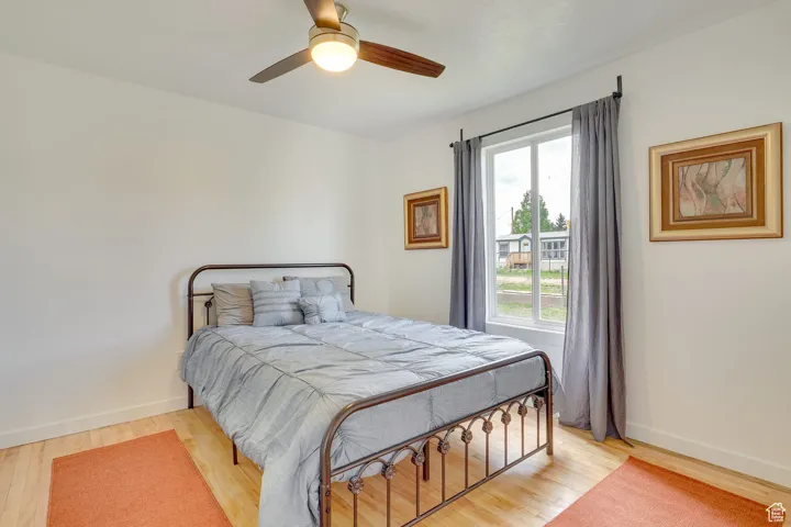 Bedroom with light wood-type flooring and ceiling fan