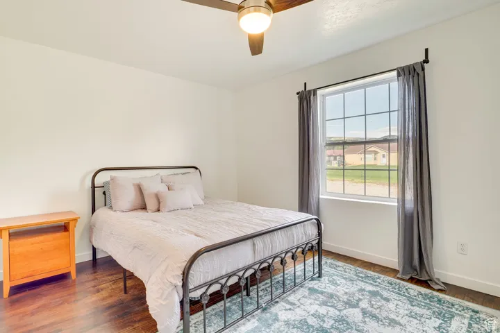 Bedroom featuring wood finished floors and a ceiling fan