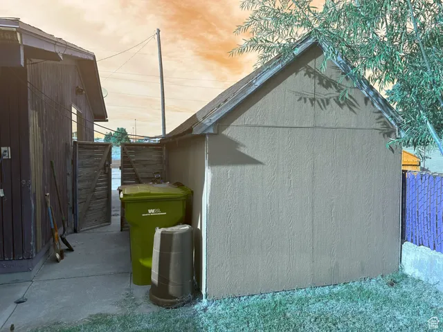 View of side of home featuring an outdoor structure