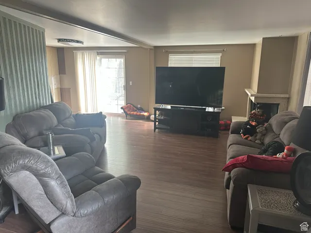 Living room with wood finished floors and a fireplace