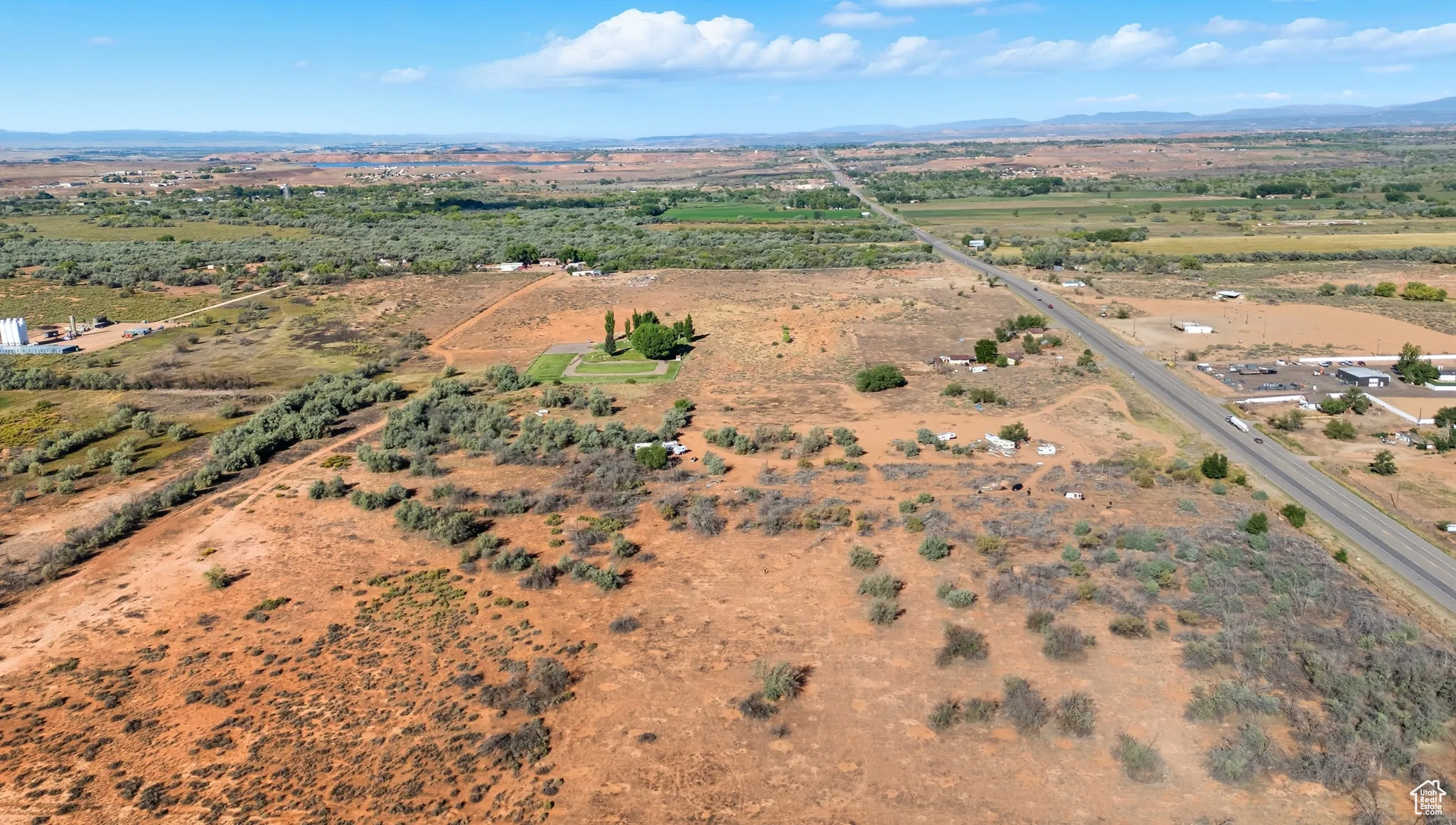 Aerial view of property and surrounding area featuring rural landscape