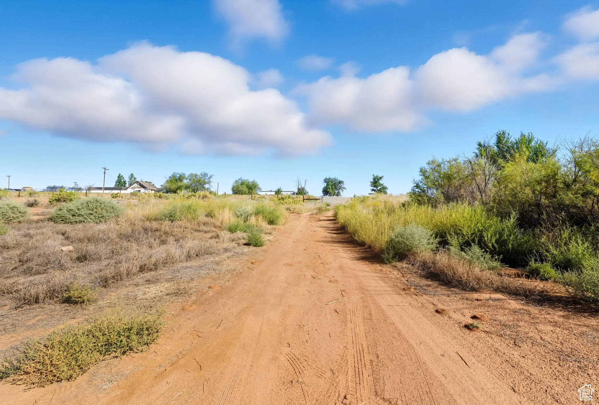 View of dirt / gravel road with a rural view