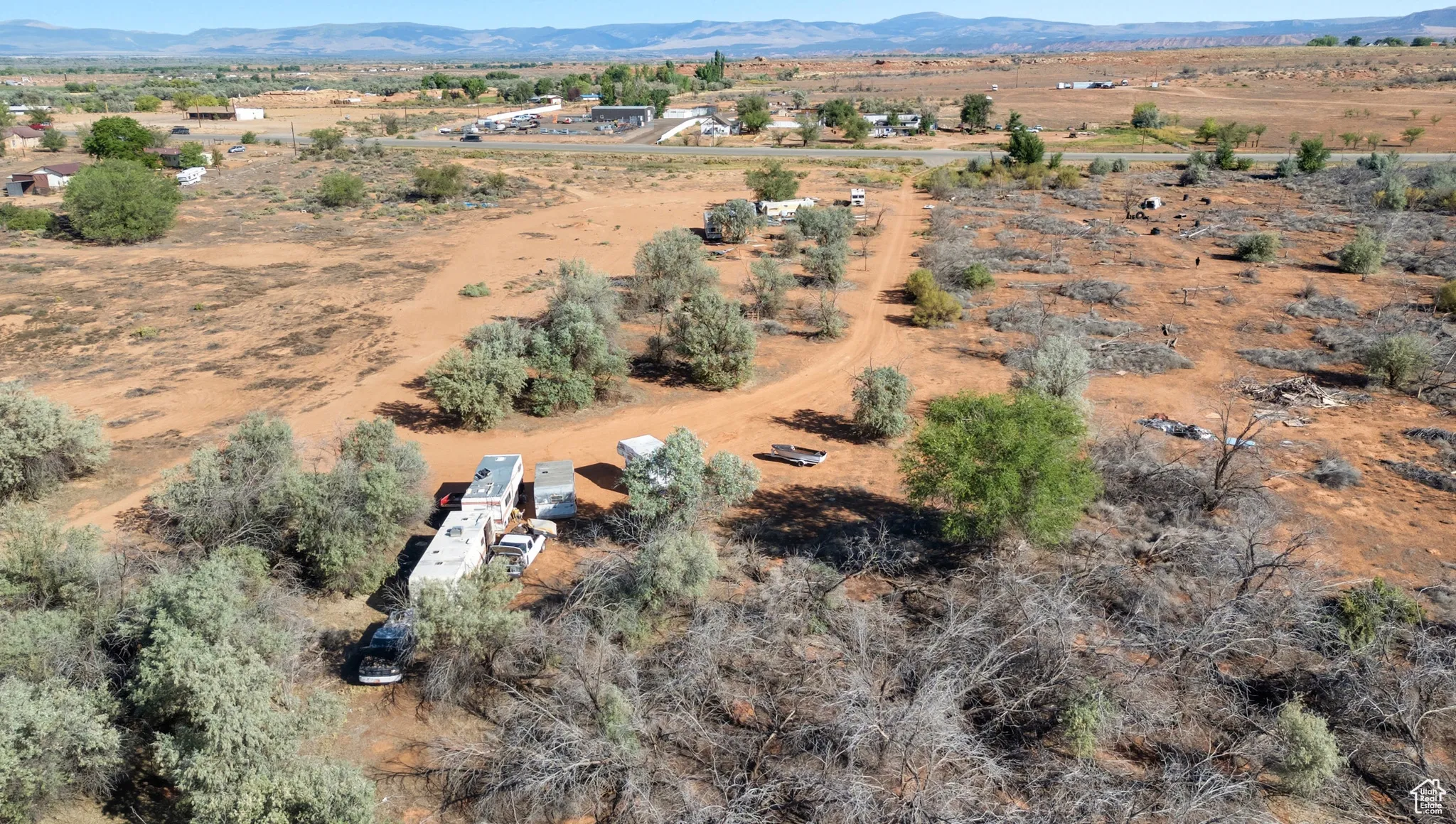 Aerial view of property and surrounding area with a mountain backdrop and rural landscape