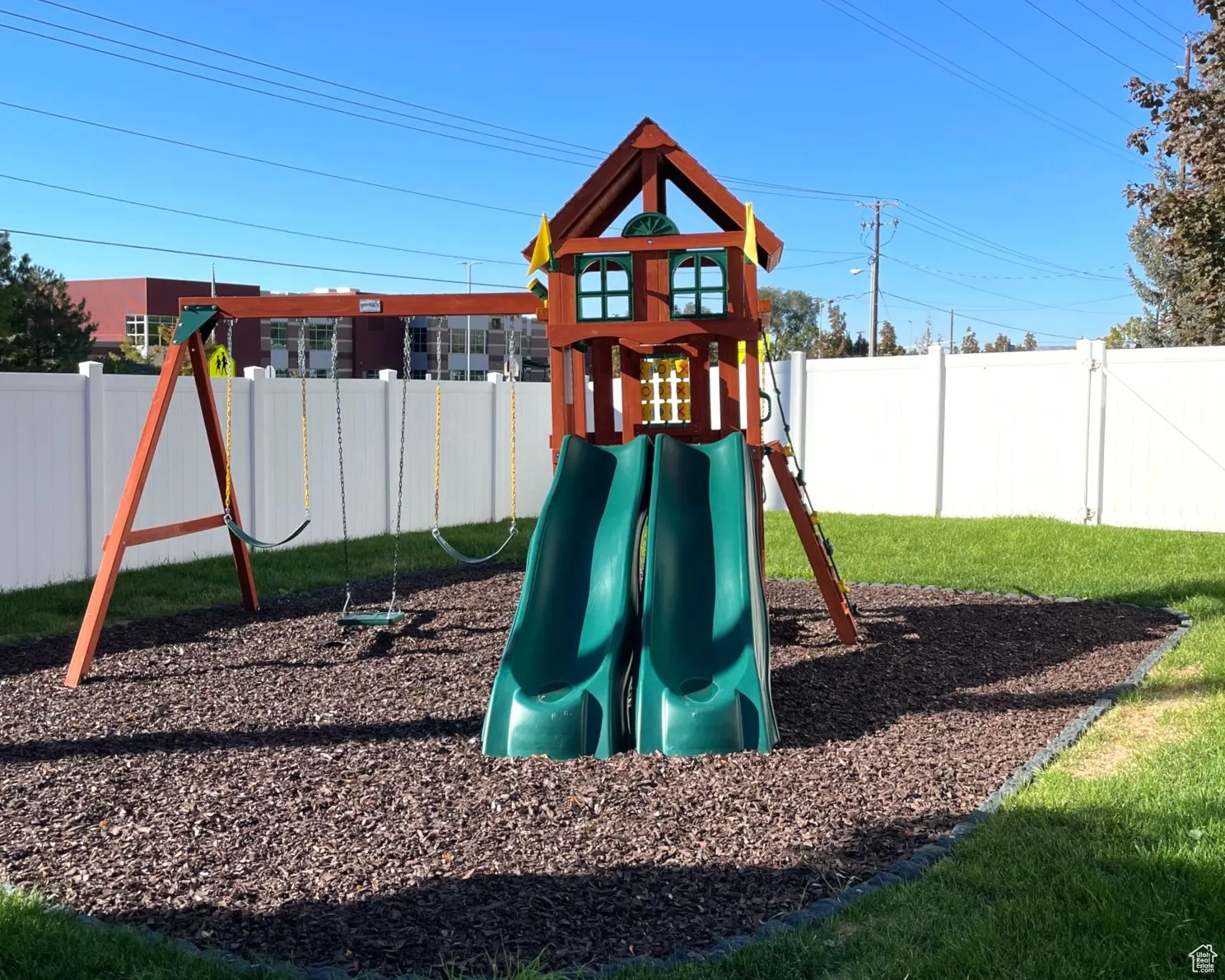 View of jungle gym with a fenced backyard