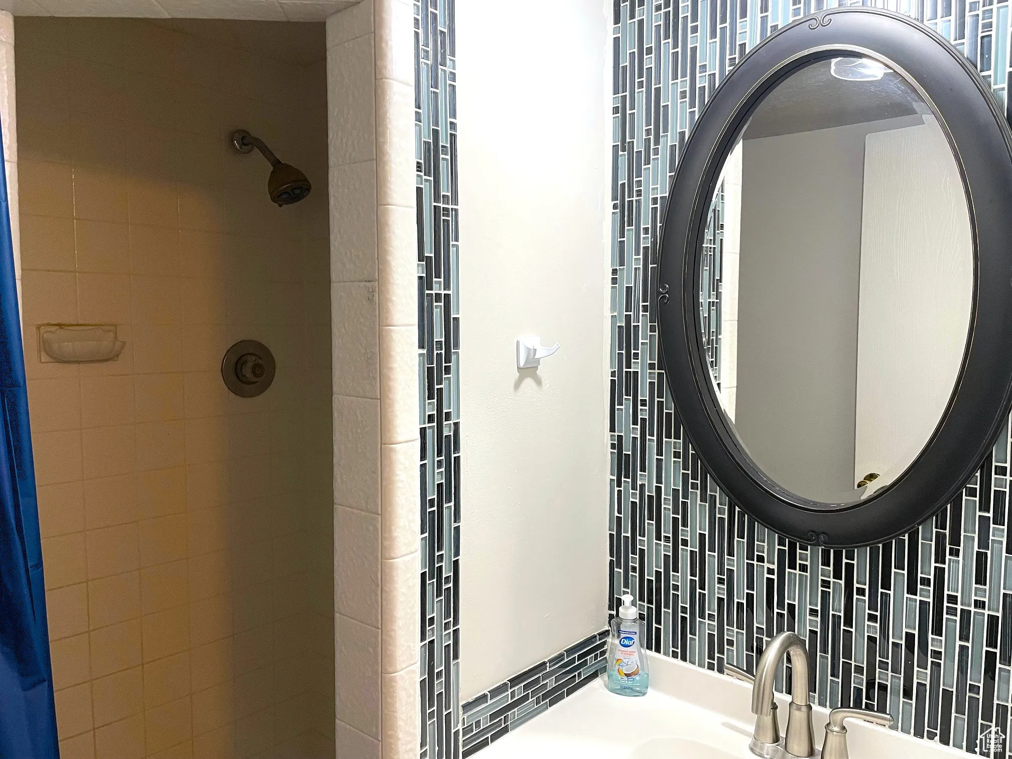 Full bath with a stall shower and vanity