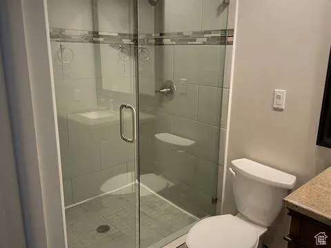 Bathroom featuring vanity and a shower stall