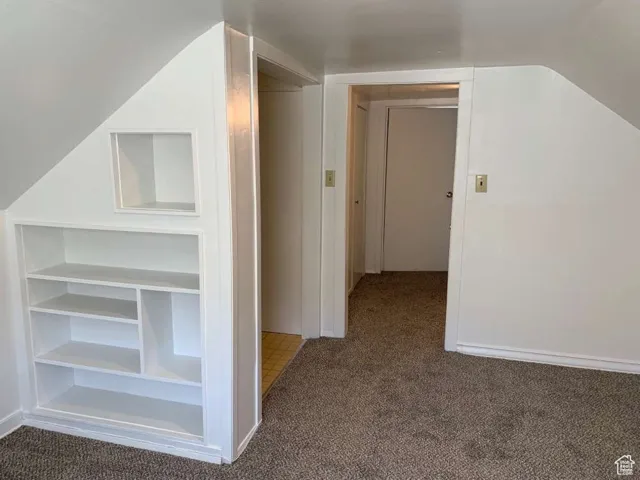 Bonus room with carpet floors and vaulted ceiling