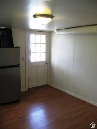 Doorway featuring wood finished floors and baseboards