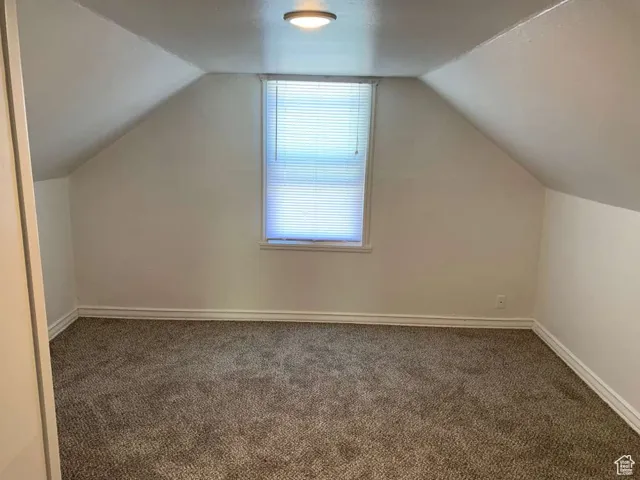 Bonus room featuring carpet flooring and vaulted ceiling