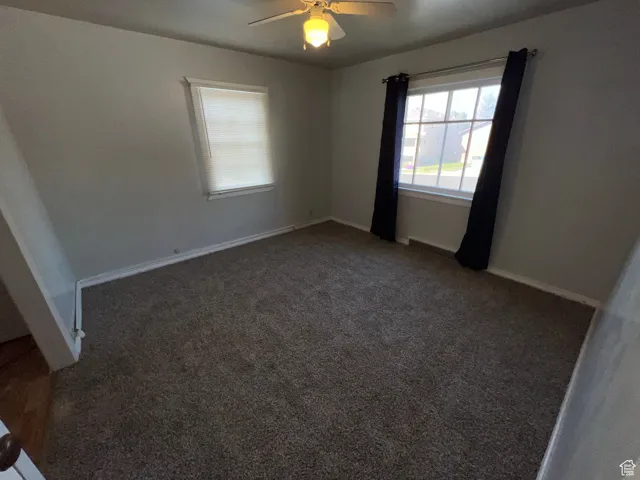 Unfurnished bedroom with carpet floors and ceiling fan