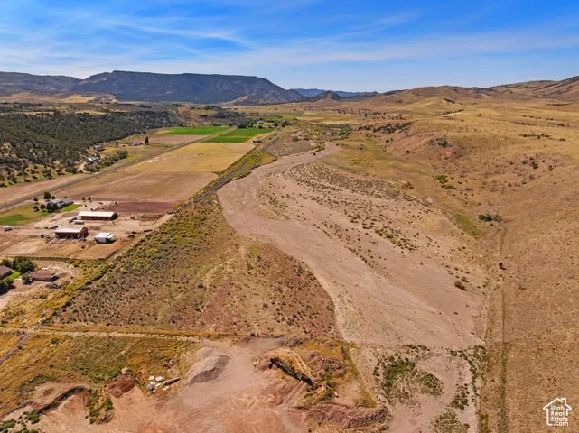 Aerial overview of property's location with mountains and rural landscape