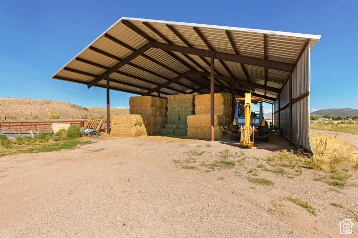 View of parking with a mountain view and a carport