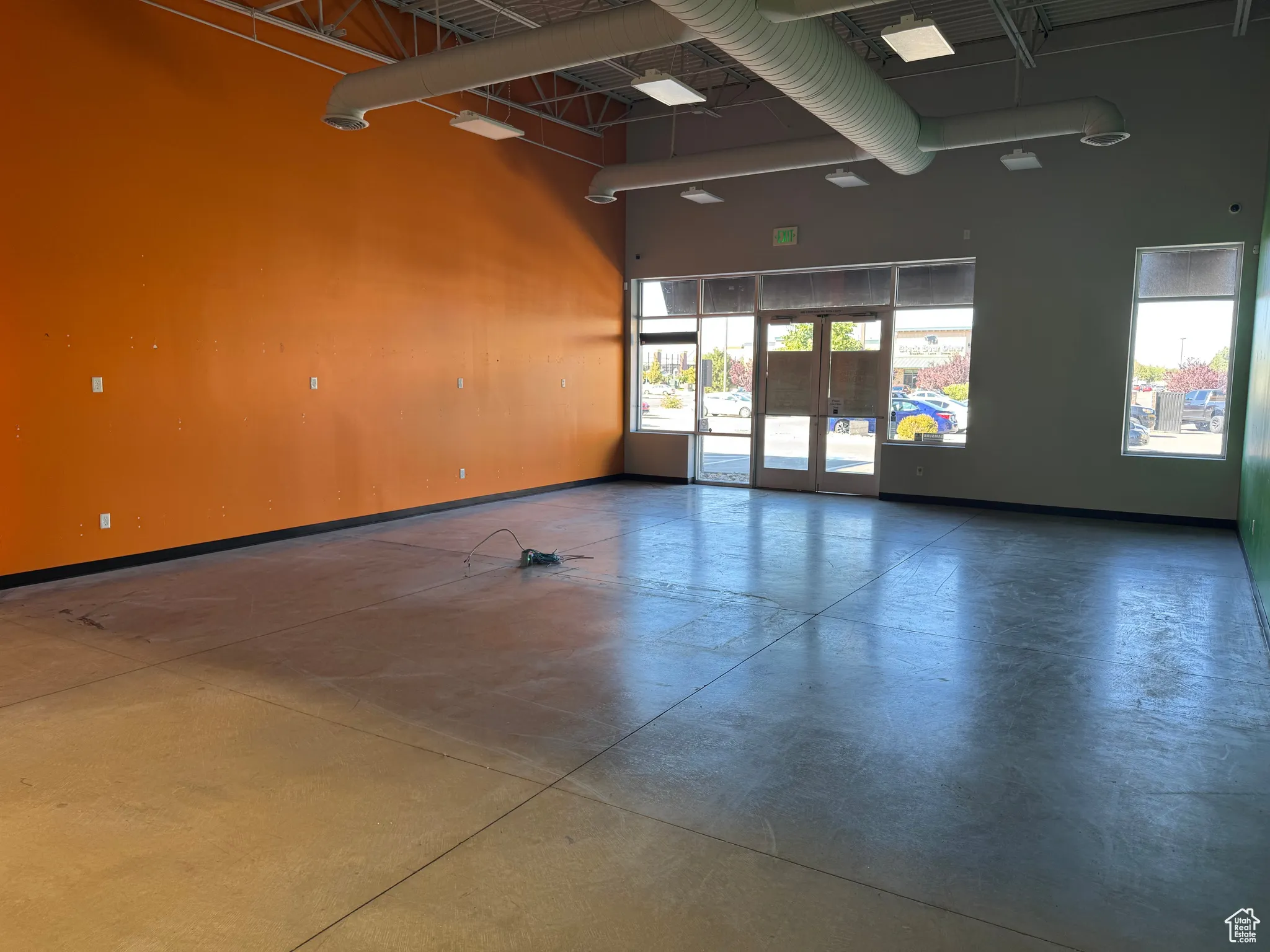 Workout room featuring a high ceiling and french doors