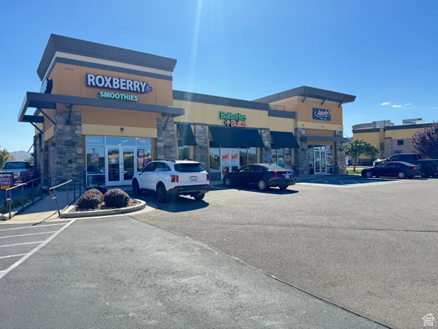 View of commercial location featuring uncovered parking