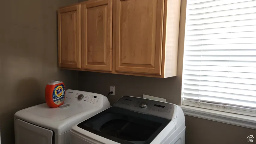 Laundry room with cabinet space and independent washer and dryer