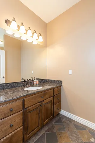 Bathroom with vanity and stone tile flooring