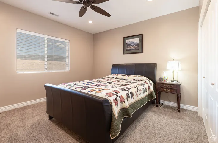 Bedroom featuring light carpet, a ceiling fan, recessed lighting, and a closet