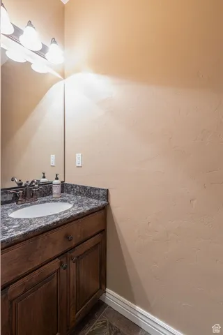 Bathroom featuring vanity and baseboards