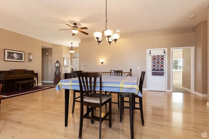 Dining area featuring light wood-type flooring, a chandelier, ceiling fan, and recessed lighting