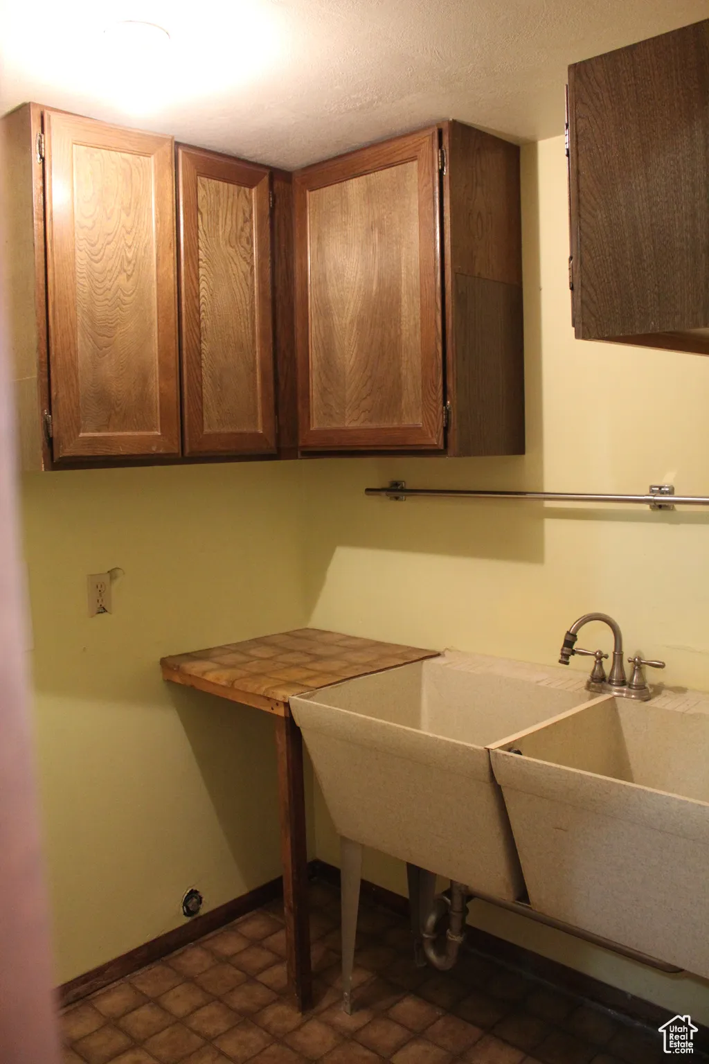 Washroom featuring baseboards and cabinet space