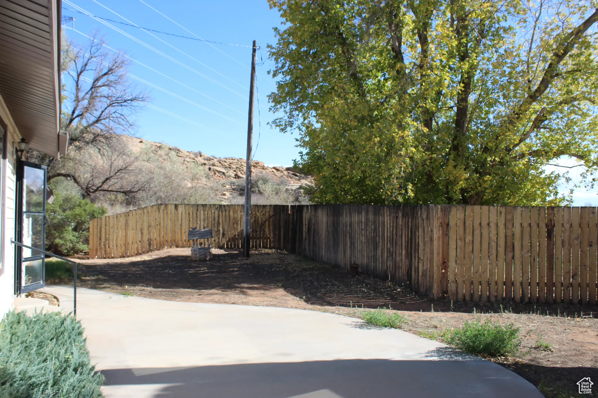 Fenced backyard with a patio