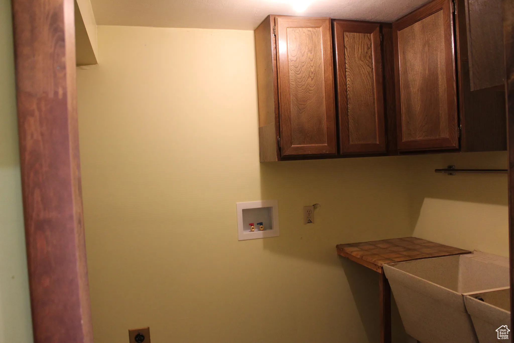 Laundry area with washer hookup, cabinet space, and electric dryer hookup