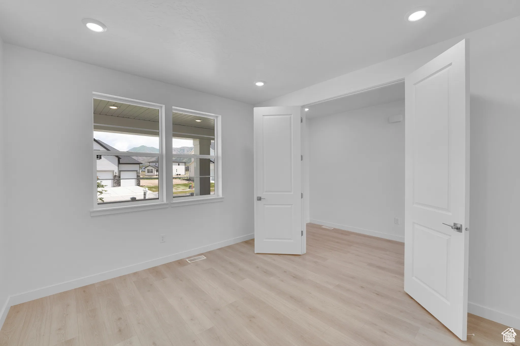 Unfurnished bedroom with light wood-type flooring and recessed lighting