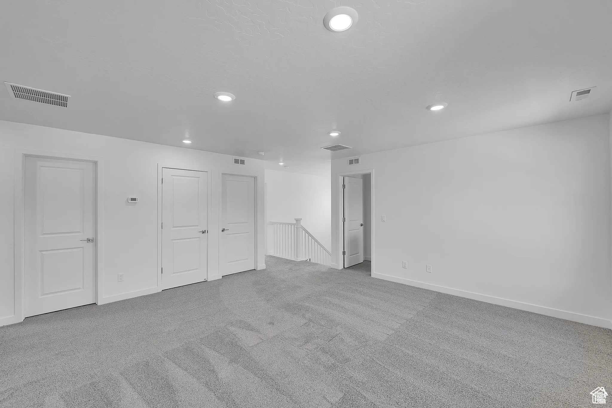 Basement featuring light colored carpet and recessed lighting