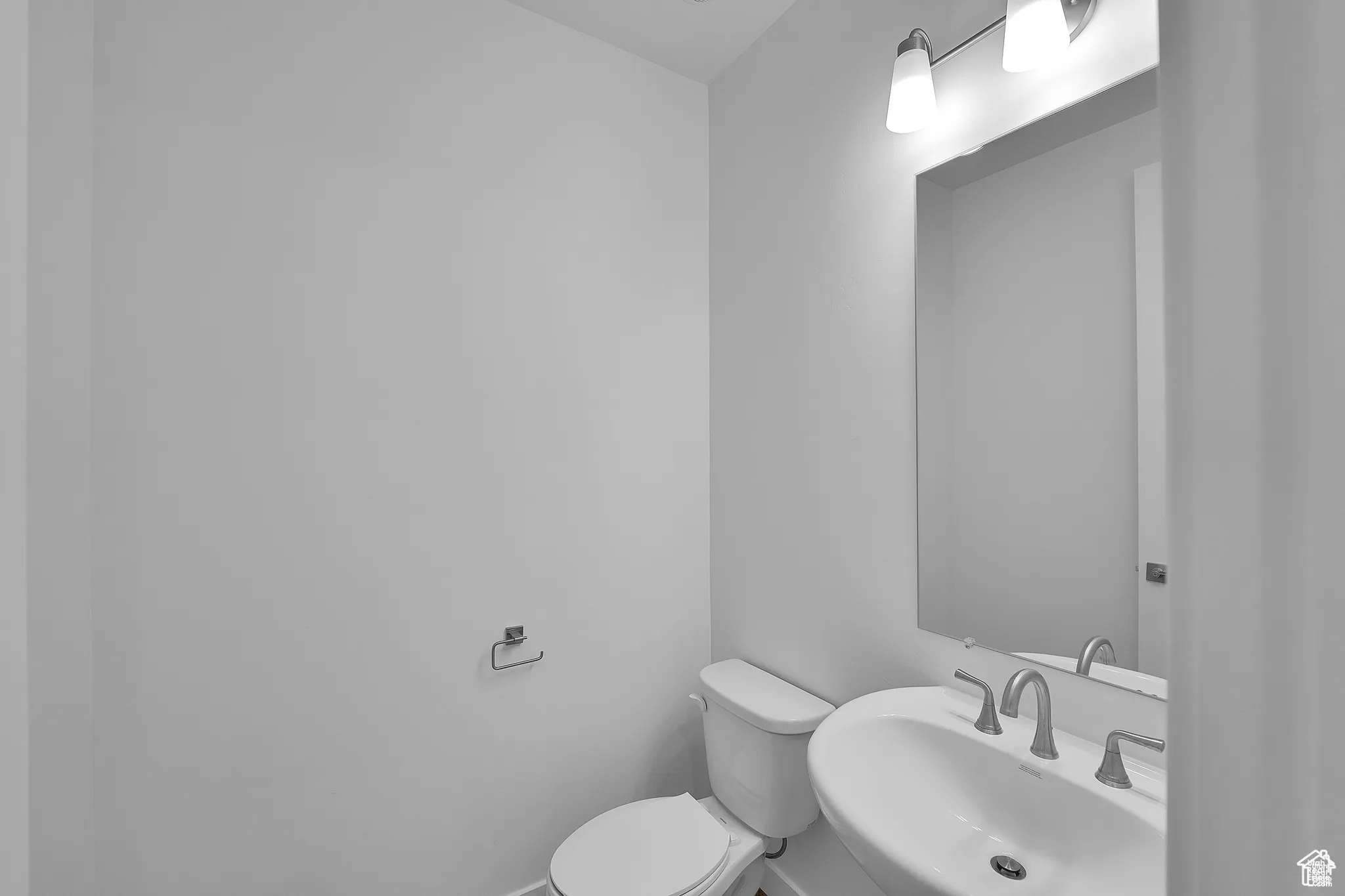 Half bathroom featuring a sink and toilet