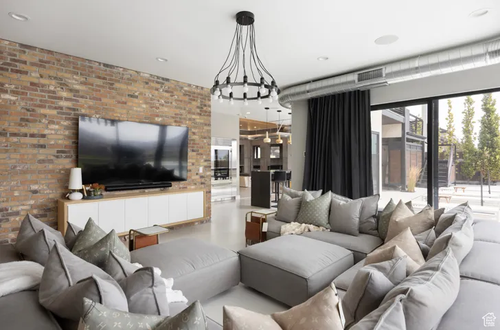 Living area with brick wall and recessed lighting