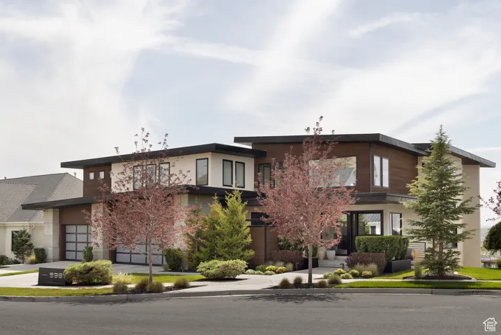 View of front of house with driveway and a garage