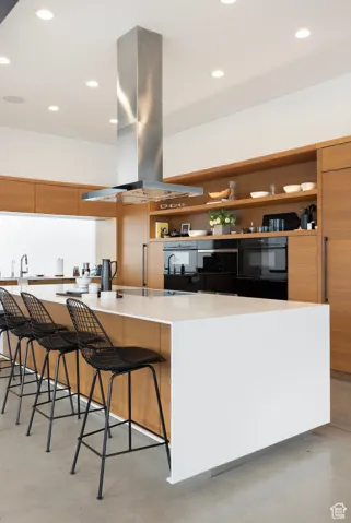 Kitchen featuring recessed lighting, open shelves, modern cabinets, and island range hood