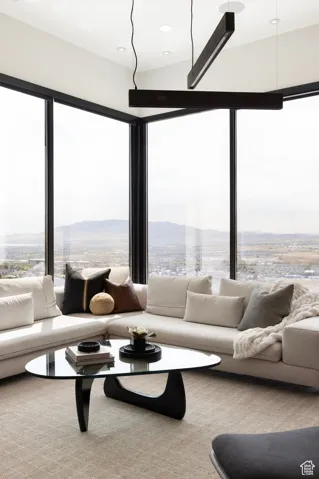 Living room with a mountain view and light carpet