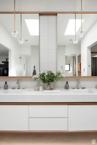 Full bathroom with a skylight and double vanity