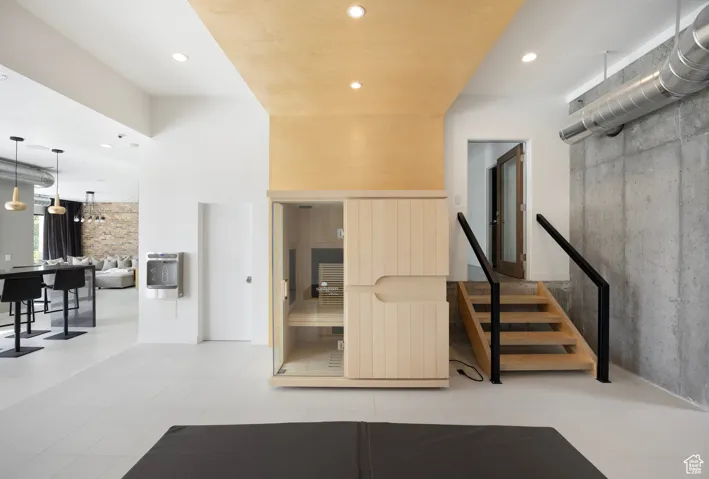 Staircase featuring a sauna / steam room and recessed lighting