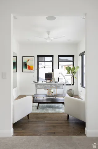 Living room with a desk and hardwood / wood-style flooring