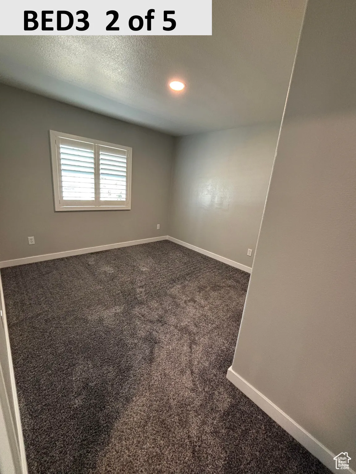Bedroom 3 featuring dark carpet, a textured ceiling, and recessed lighting