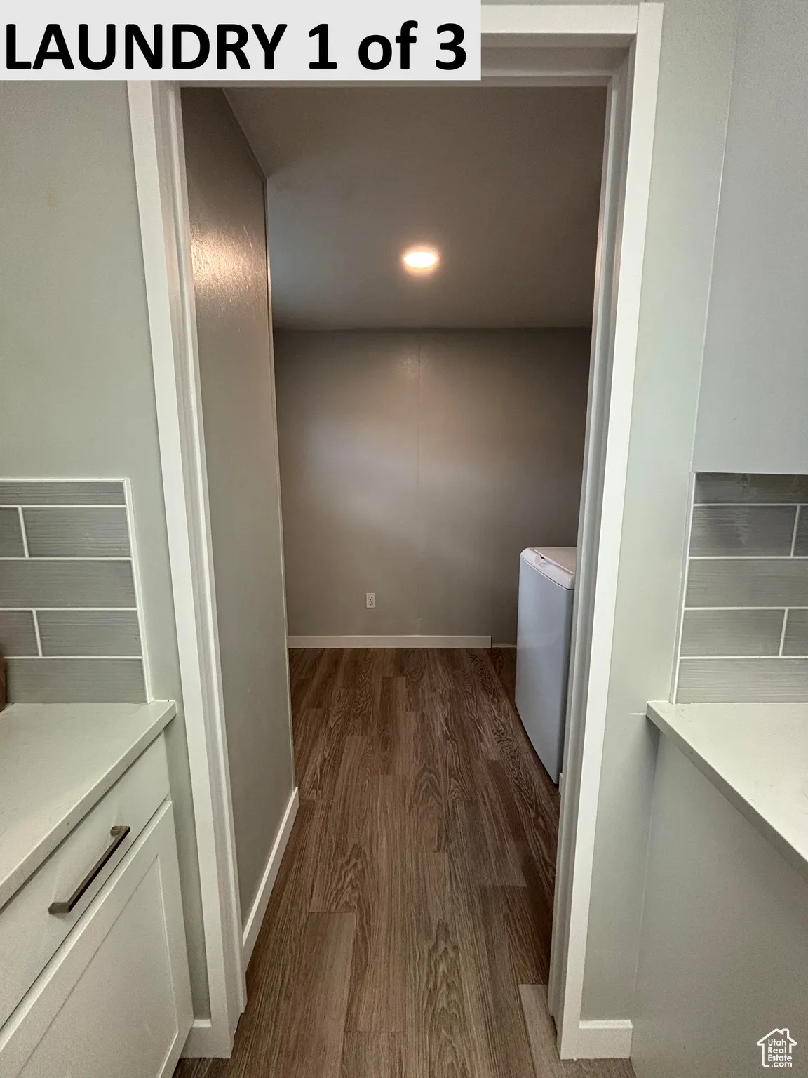 Laundry room with LVP flooring and washer/clothes dryer