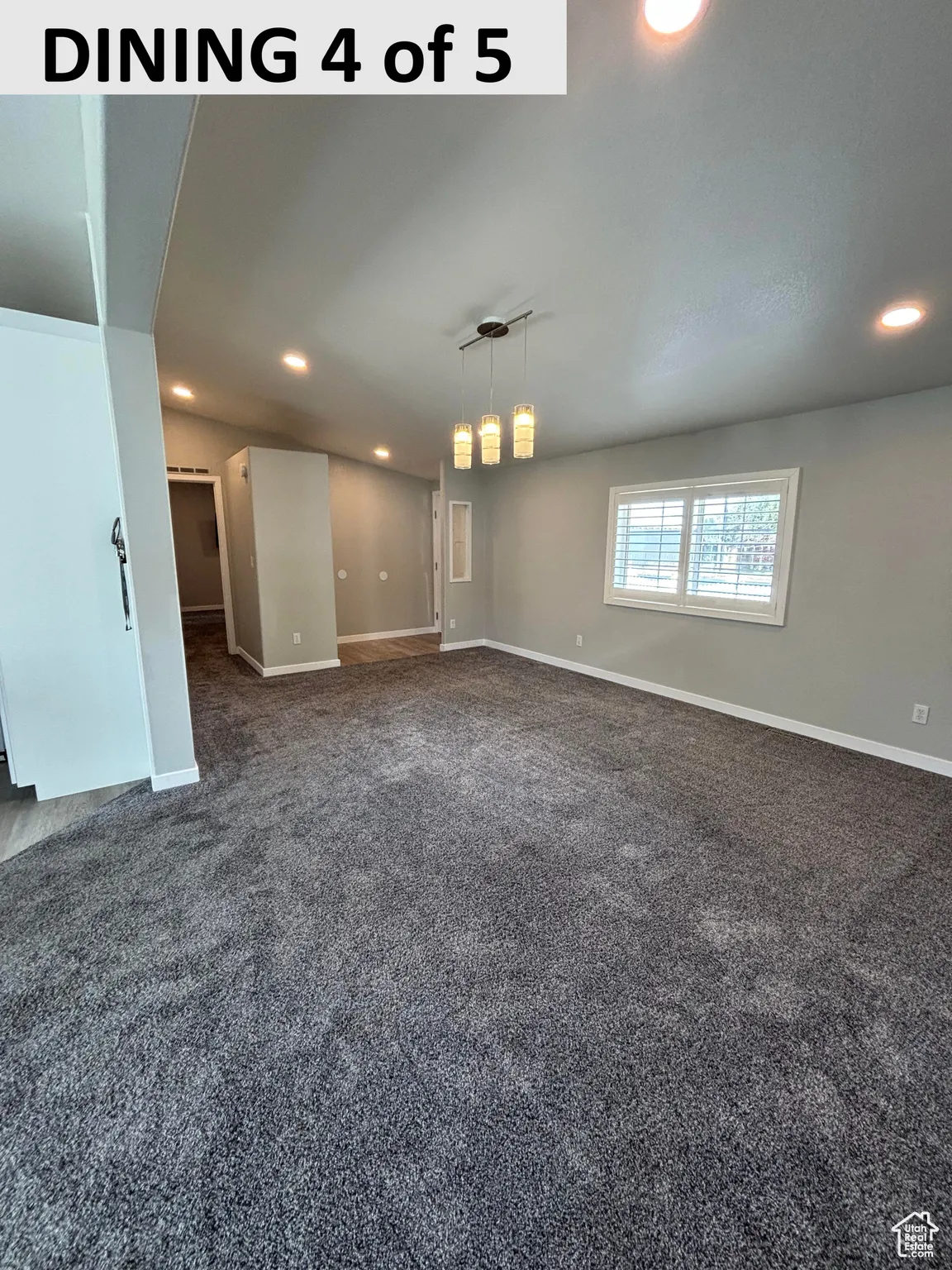 Empty room featuring recessed lighting and dark carpet