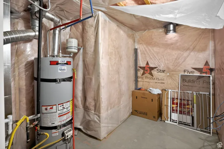 Utility room featuring secured water heater