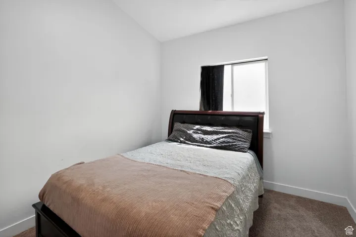 Carpeted bedroom featuring baseboards
