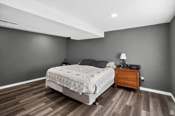 Bedroom featuring dark wood-style floors and recessed lighting