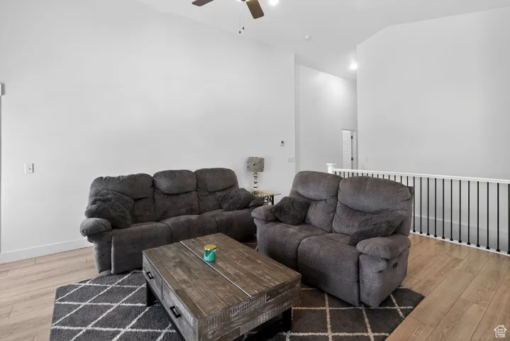 Living room with a ceiling fan and light wood-style flooring