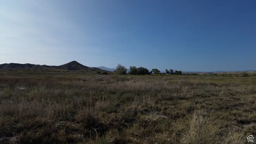 View of mountain backdrop featuring rural landscape