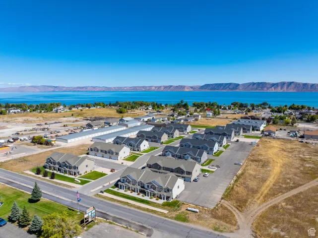 Aerial perspective of suburban area featuring a water and mountain view