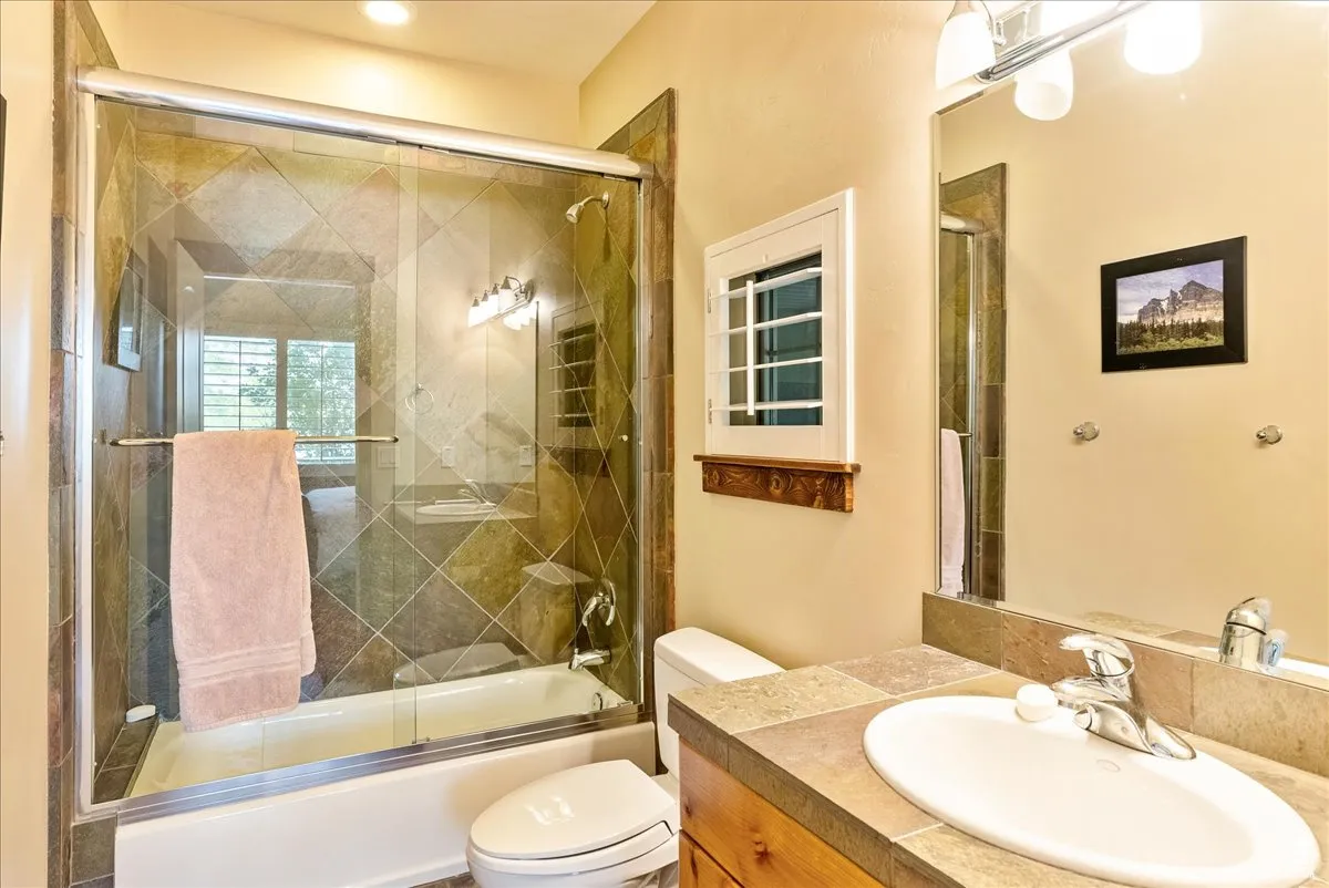 Full bathroom featuring enclosed tub / shower combo and vanity