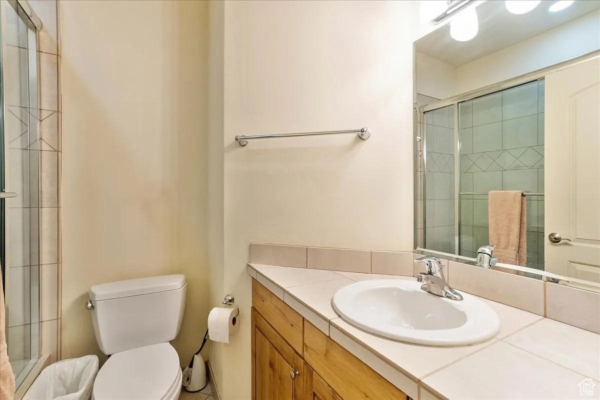 Bathroom featuring vanity and a shower stall