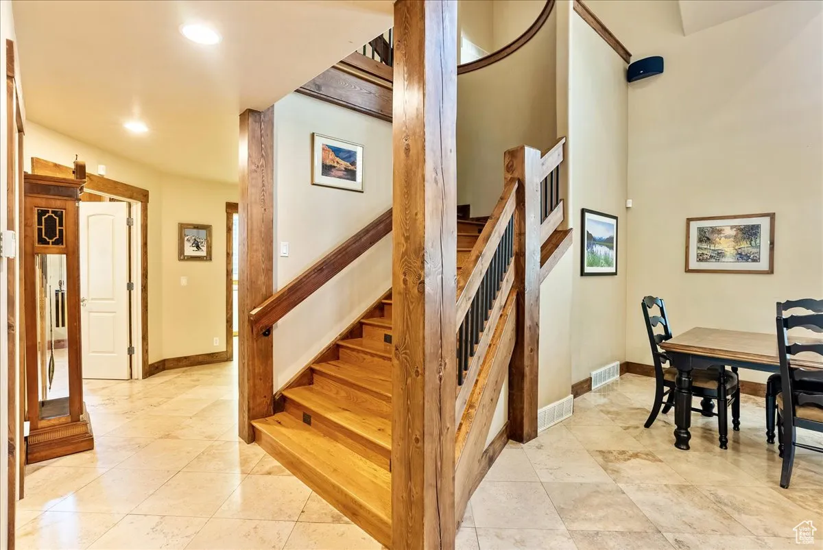 Stairway featuring recessed lighting and tile patterned floors